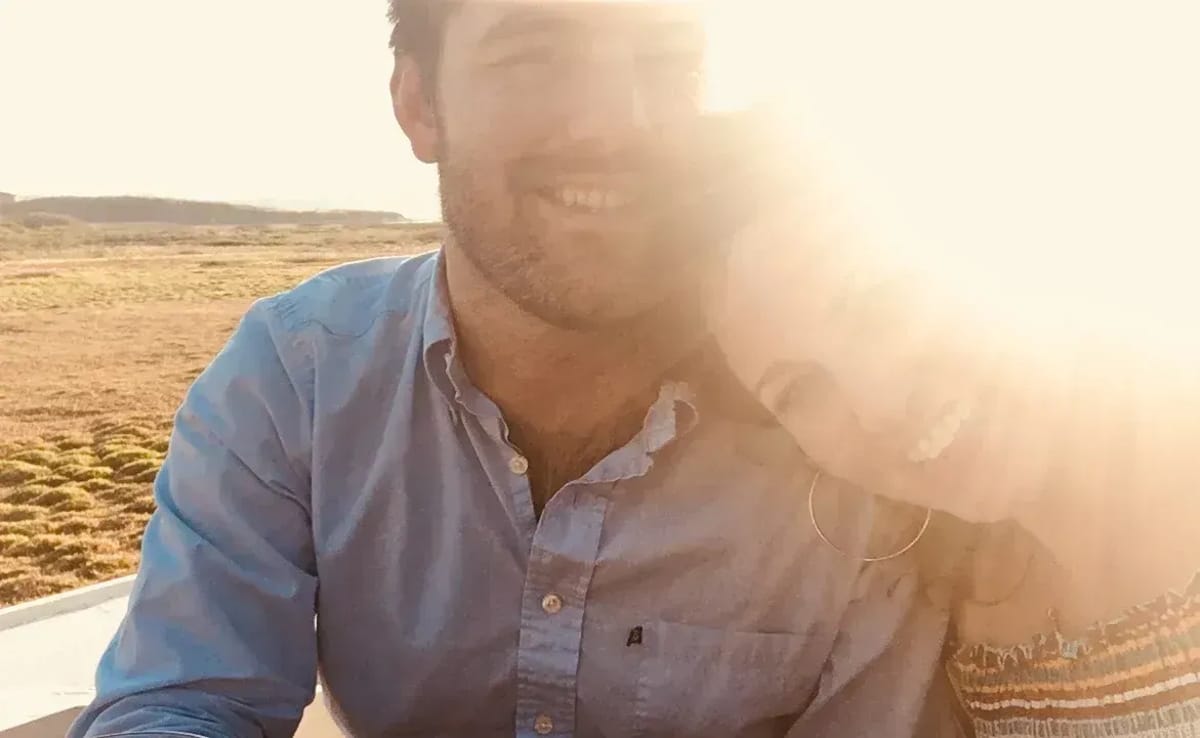 Kara and Robert with a lens flare behind them