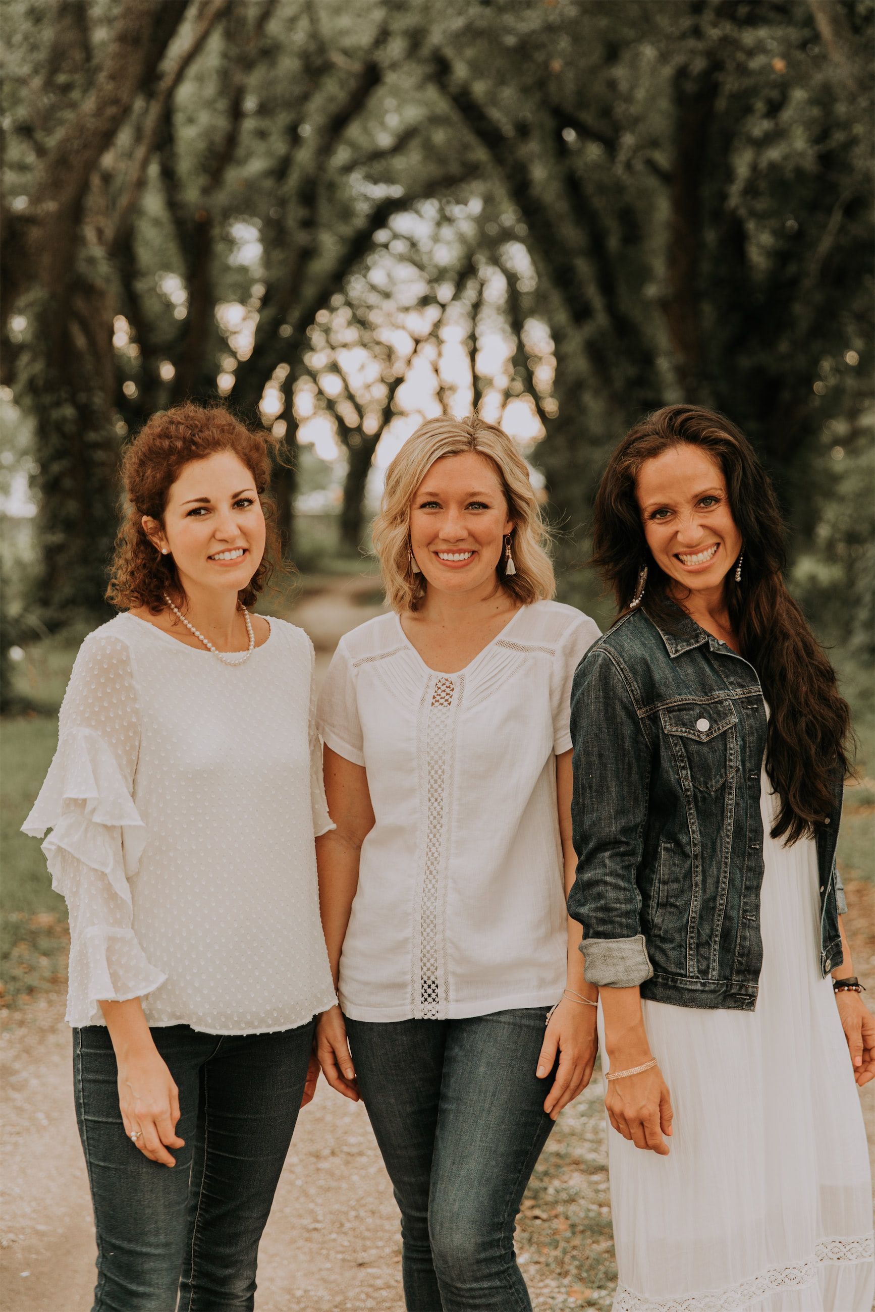 Kara Klein Oubre, Christine Simpson Wessa, and Maria Spears on a path near trees posing together variation two