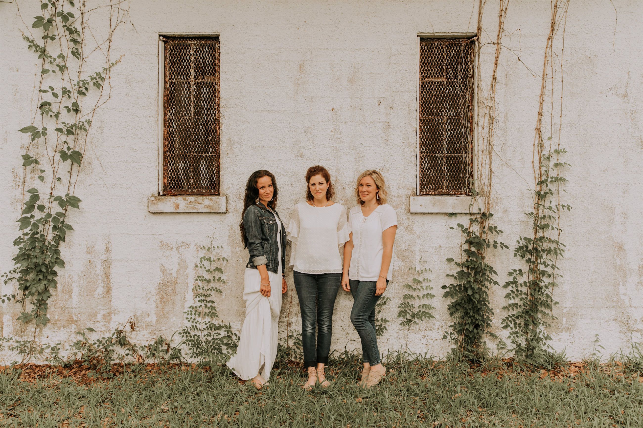 Kara Klein Oubre, Christine Simpson Wessa, and Maria Spears in front of a white stone background standing
